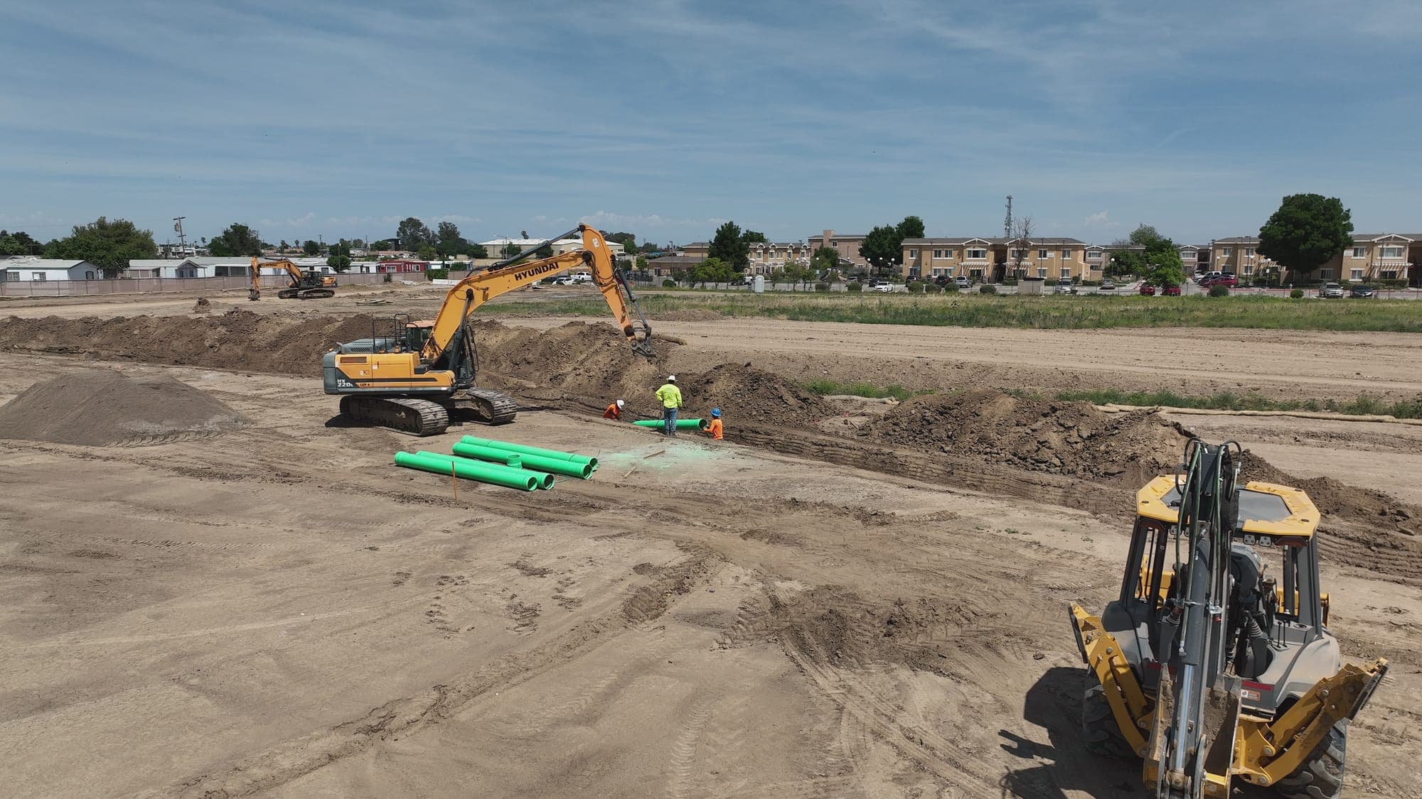 Aerial view of construction site with heavy machinery and trucks